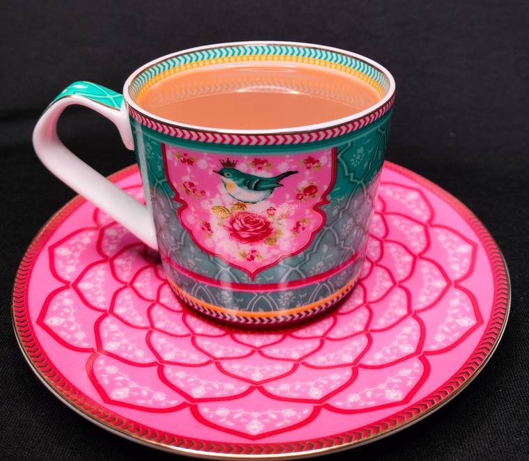 Masala chai in a floral cup styled on a pink plate, product photography by Propix Jaipur