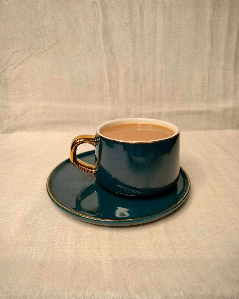 Chai in a teal cup on a neutral backdrop, minimal product photography by Propix